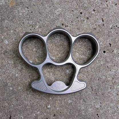 Titanium bottle opener on a concrete surface